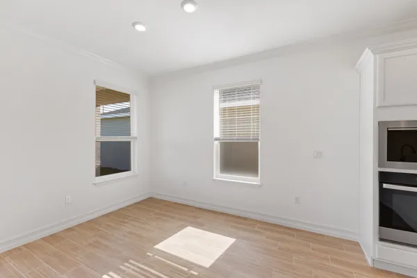 an empty room with windows and closet