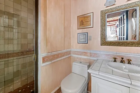 a white toilet sitting next to a bathroom sink