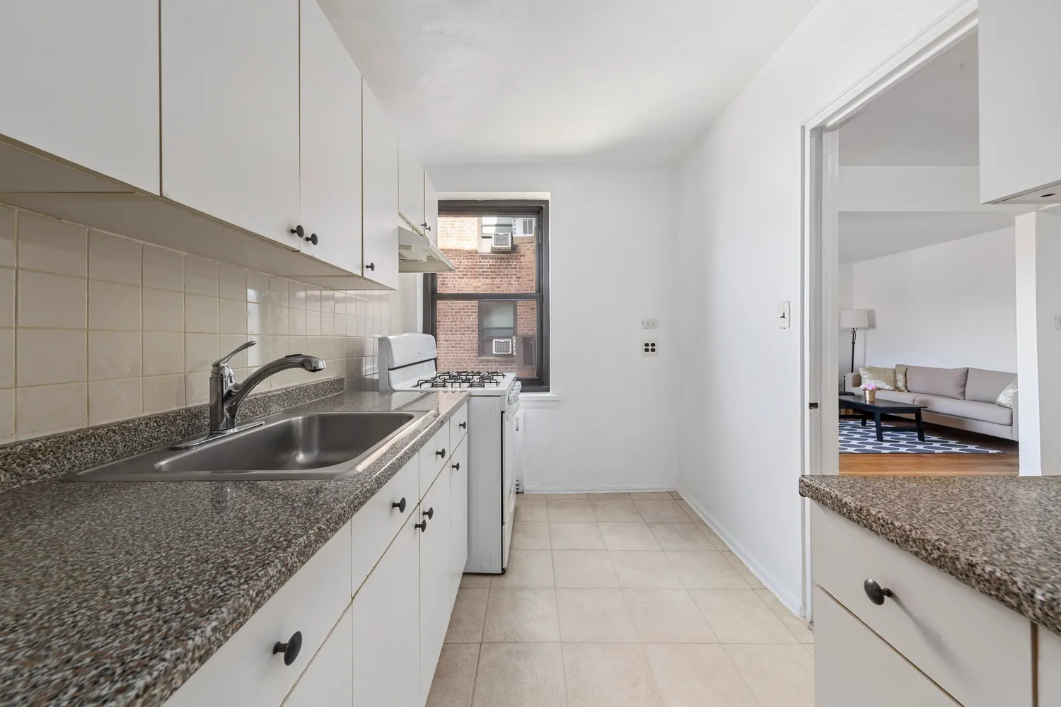 a kitchen with a sink and a counter top space