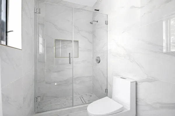 a bathroom with a toilet and a shower