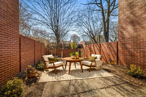 a view of a patio with iron fence