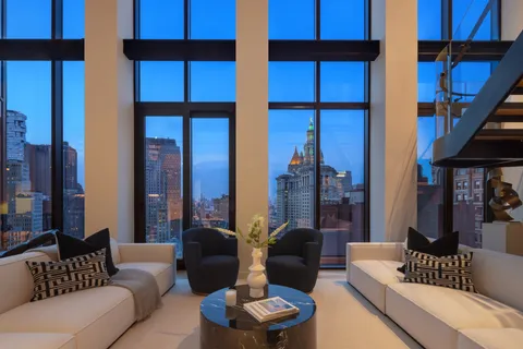 a dining room with furniture and a floor to ceiling window