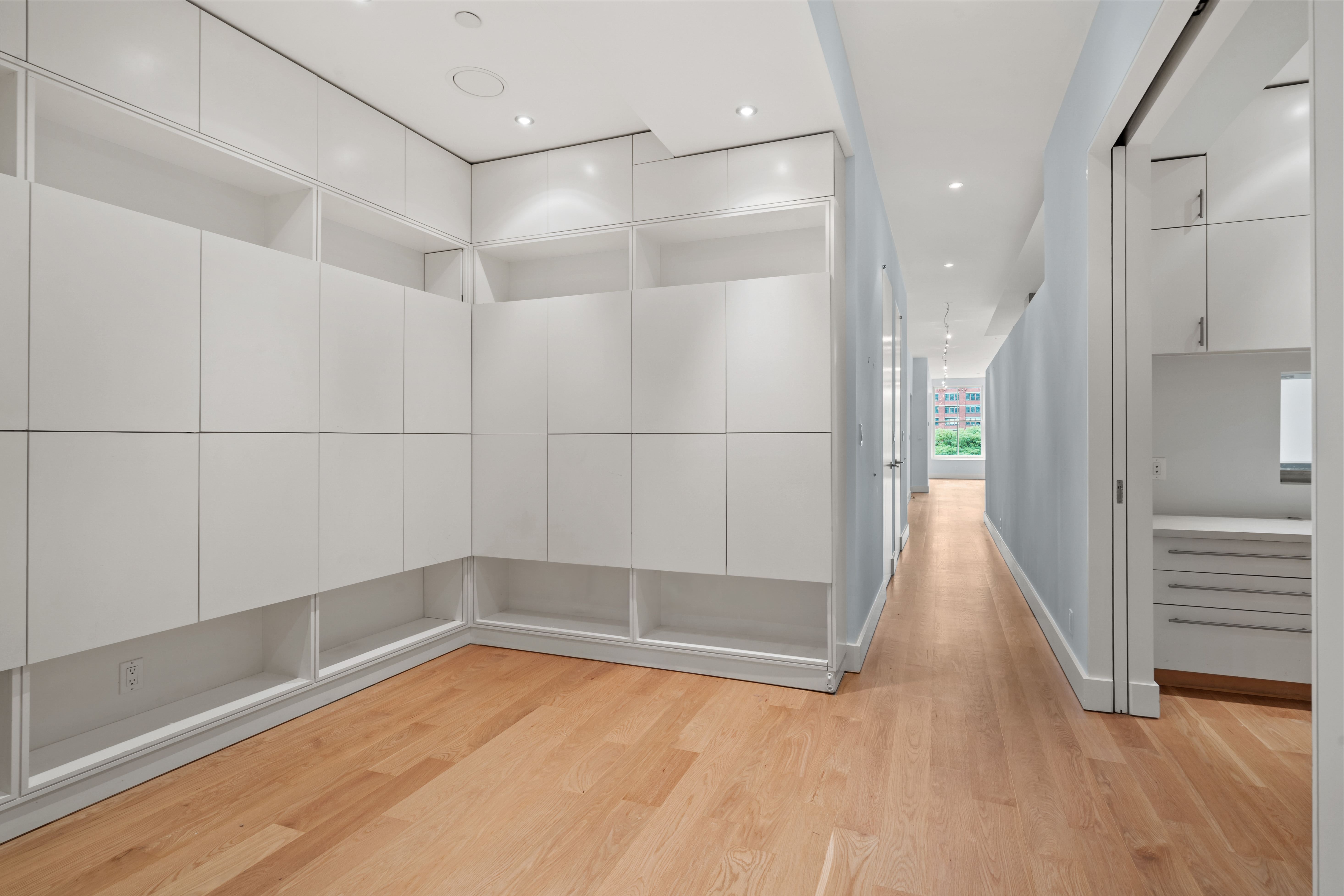 32 Laight Street, Unit 5 Manhattan, NY 10013 - Photo 25 of 31 a view of a hallway with wooden floor and a bathroom