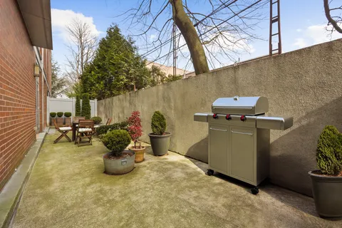 a view of a backyard with table and chairs