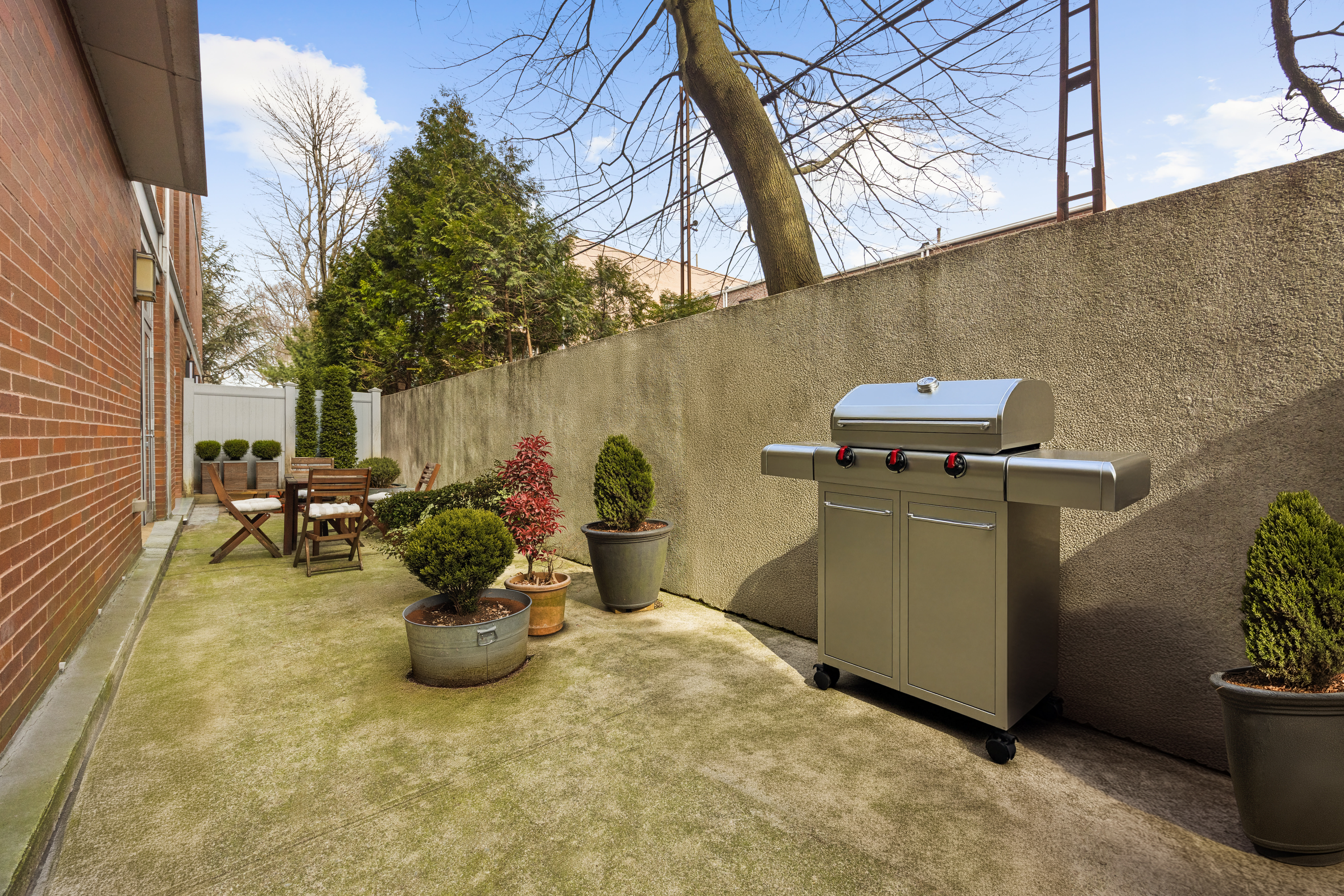 35 McDonald Avenue, Unit 1E Brooklyn, NY 11218 - Photo 3 of 9 a view of a backyard with table and chairs