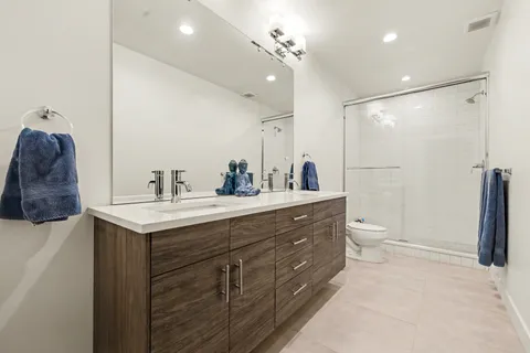 a bathroom with a sink double vanity and a mirror