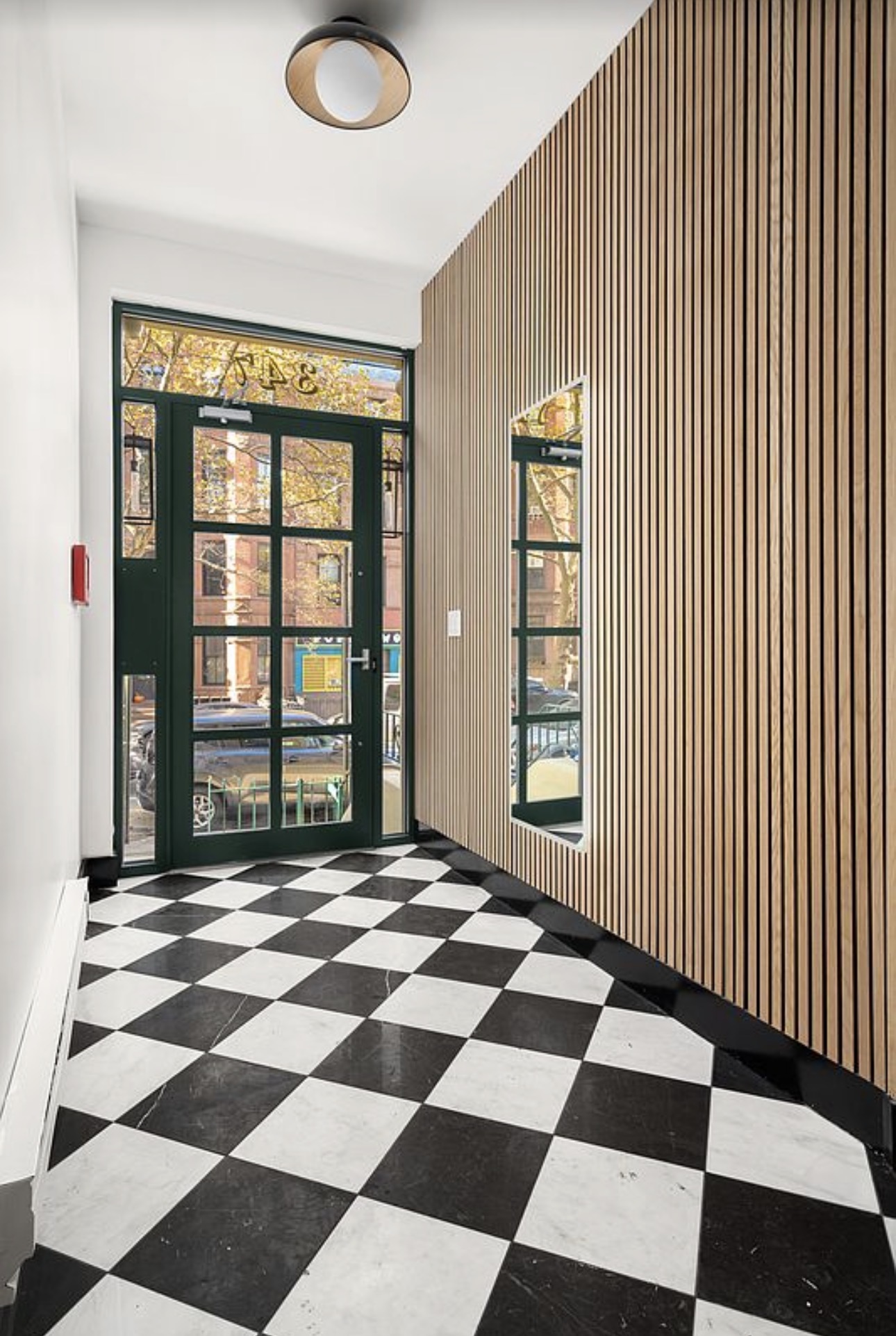 347 6th Avenue, Unit 1 Brooklyn, NY 11215 - Photo 12 of 15 a view of a livingroom with a black and white checkered floor