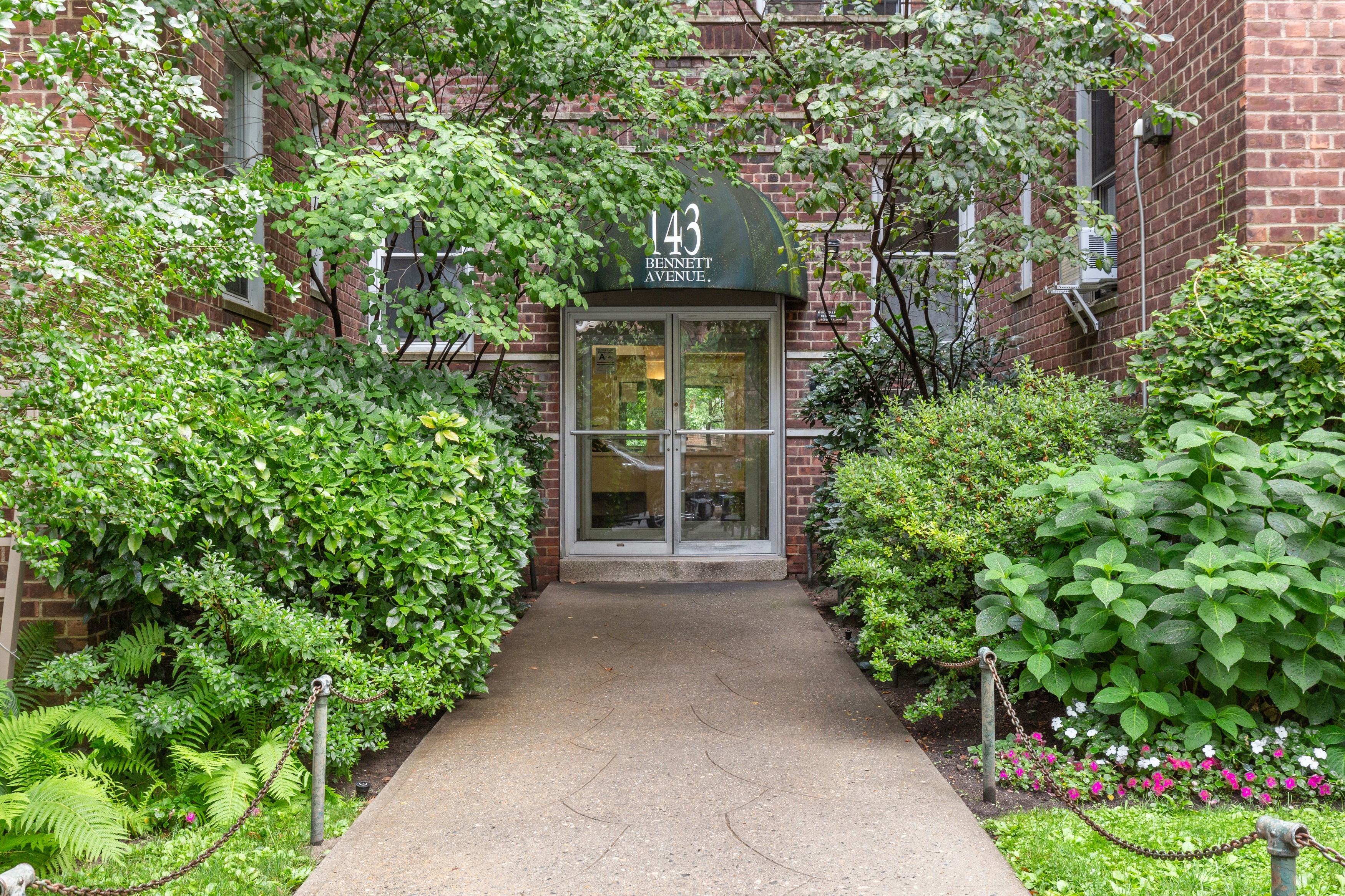 143 Bennett Avenue, Unit 6R Manhattan, NY 10040 - Photo 18 of 22 a front view of a house with a yard