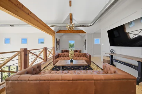 a living room with furniture wooden floor and a table