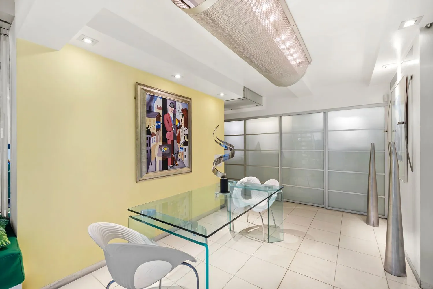 a dining room with furniture and a chandelier