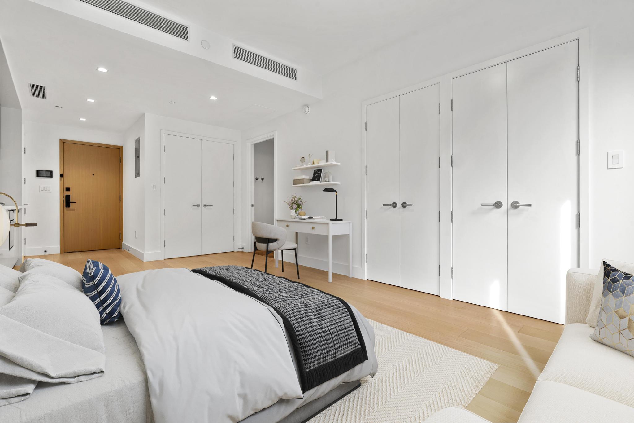 208 Delancey Street, Unit GC Manhattan, NY 10002 - Photo 2 of 12 a bedroom with a bed and a walk in closet