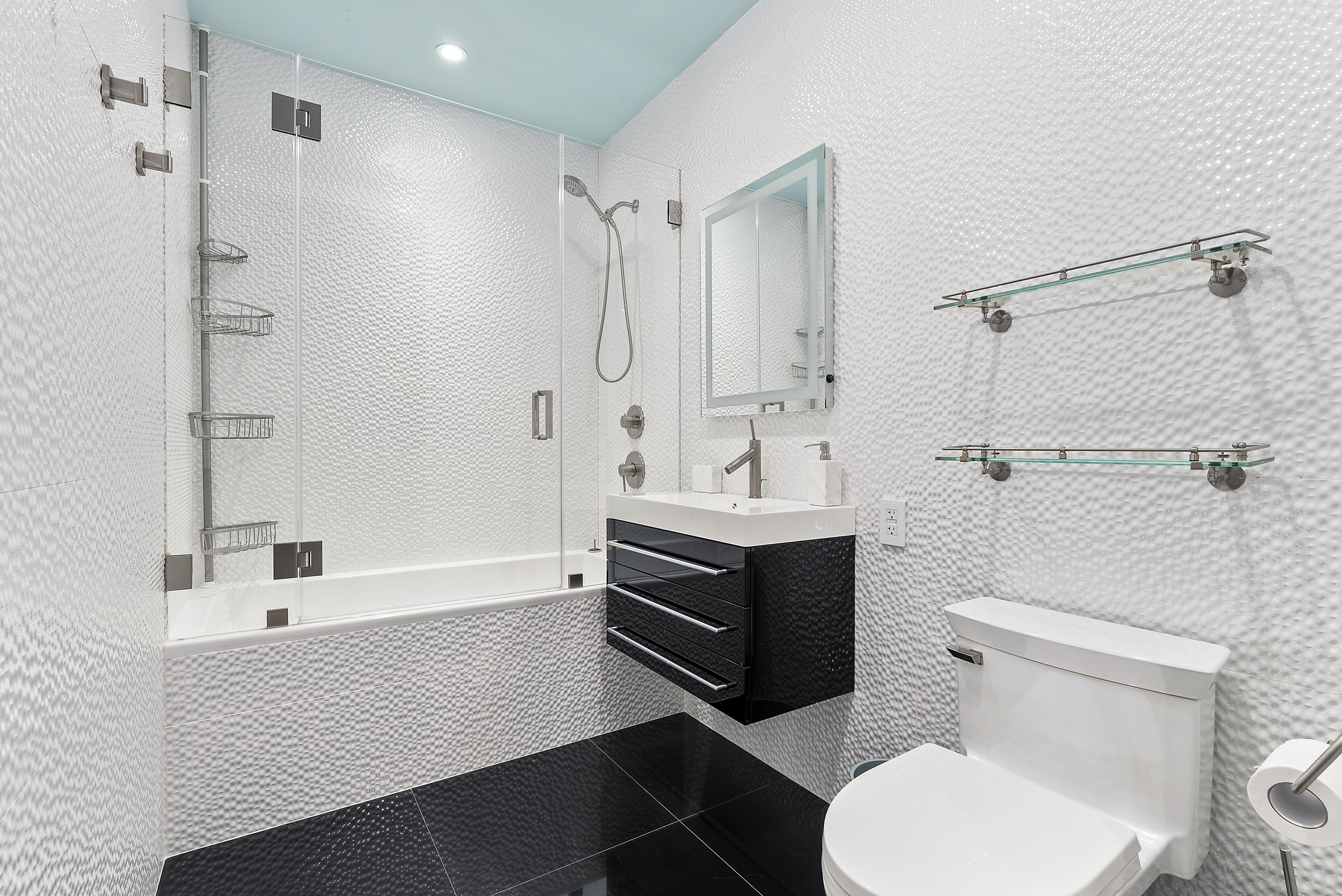 66 Leonard Street, Unit 2A Manhattan, NY 10013 - Photo 12 of 15 a bathroom with a sink a toilet and shower