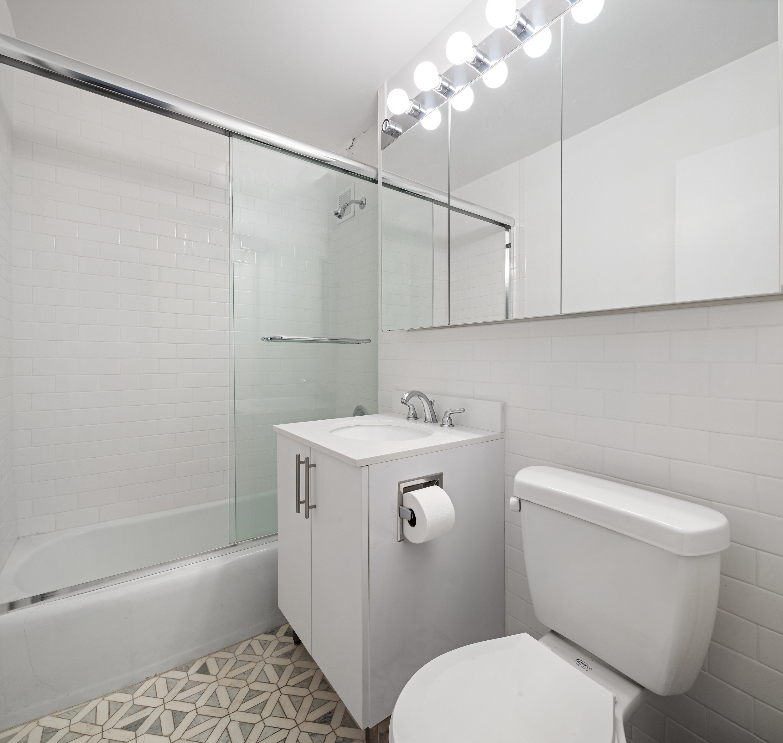 7 East 14th Street, Unit 605 Manhattan, NY 10003 - Photo 6 of 8 a bathroom with a sink a toilet and shower