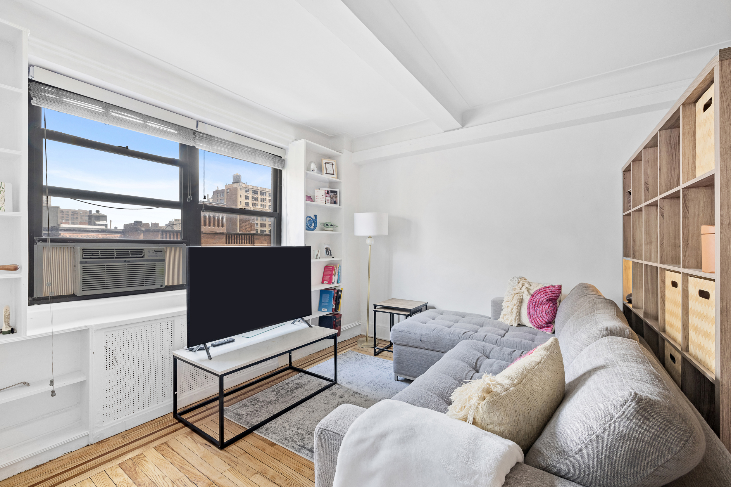 102 West 85th Street, Unit 9B Manhattan, NY 10024 - Photo 2 of 7 a living room with furniture and a flat screen tv