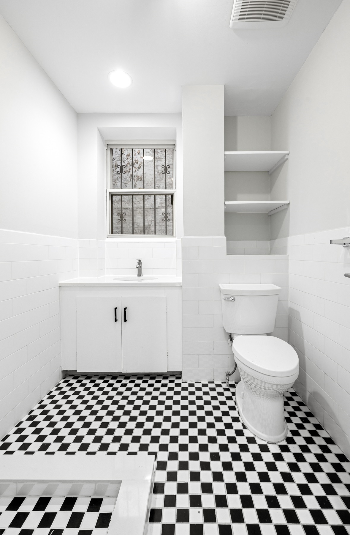 249 East Houston Street, Unit PARLOR Manhattan, NY 10002 - Photo 10 of 12 a bathroom with a toilet a sink and a window
