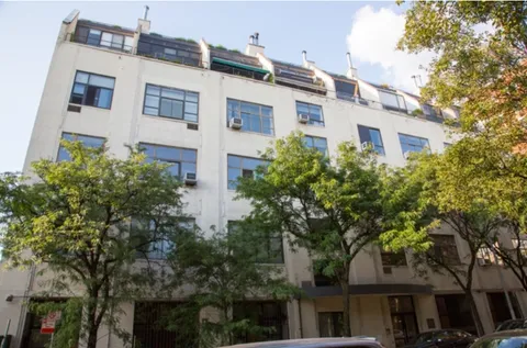 a view of a building with a tree