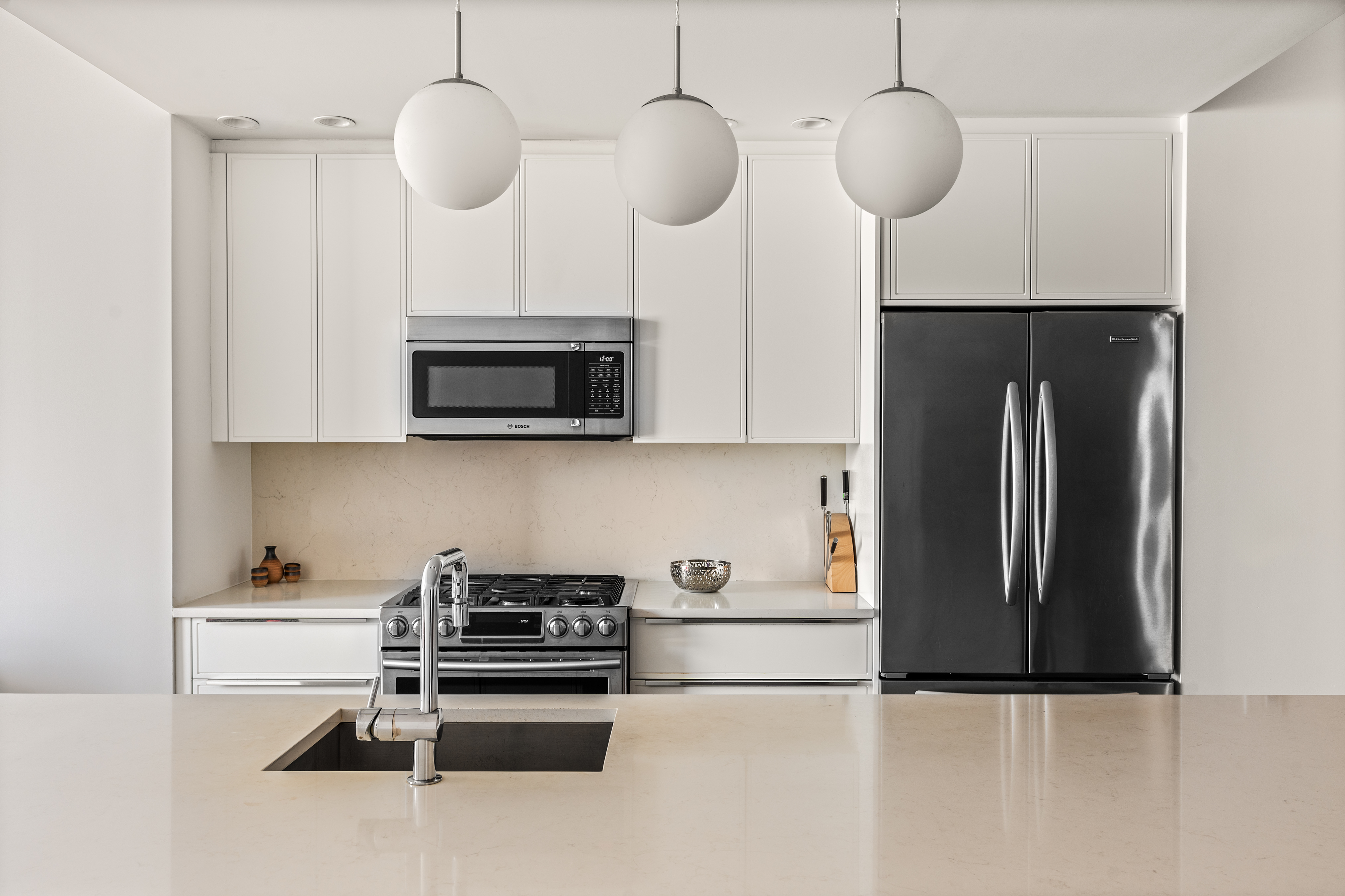 23 West 116th Street, Unit 7A Manhattan, NY 10026 - Photo 3 of 14 a kitchen with stainless steel appliances granite countertop a refrigerator a oven a sink and a microwave
