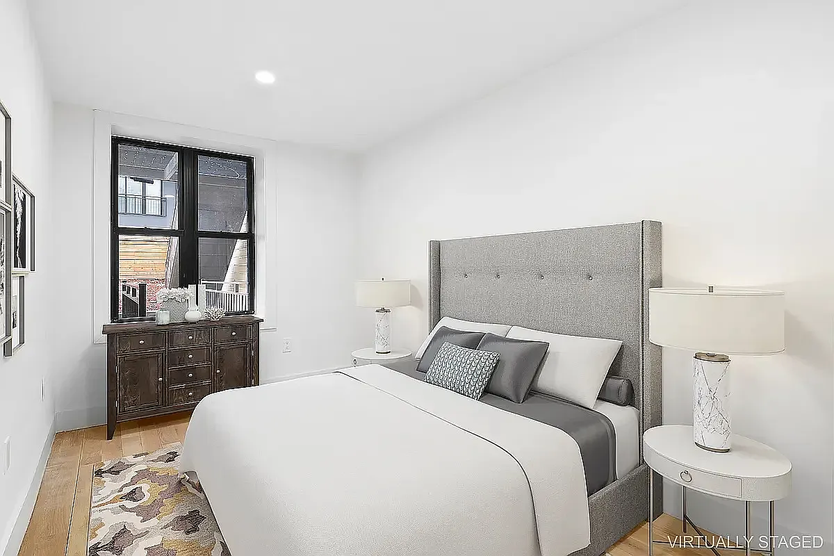 587 Van Buren Street, Unit 1 Brooklyn, NY 11221 - Photo 4 of 8 a bedroom with a bed and wooden floor