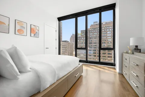 a spacious bedroom with a large bed and a large window