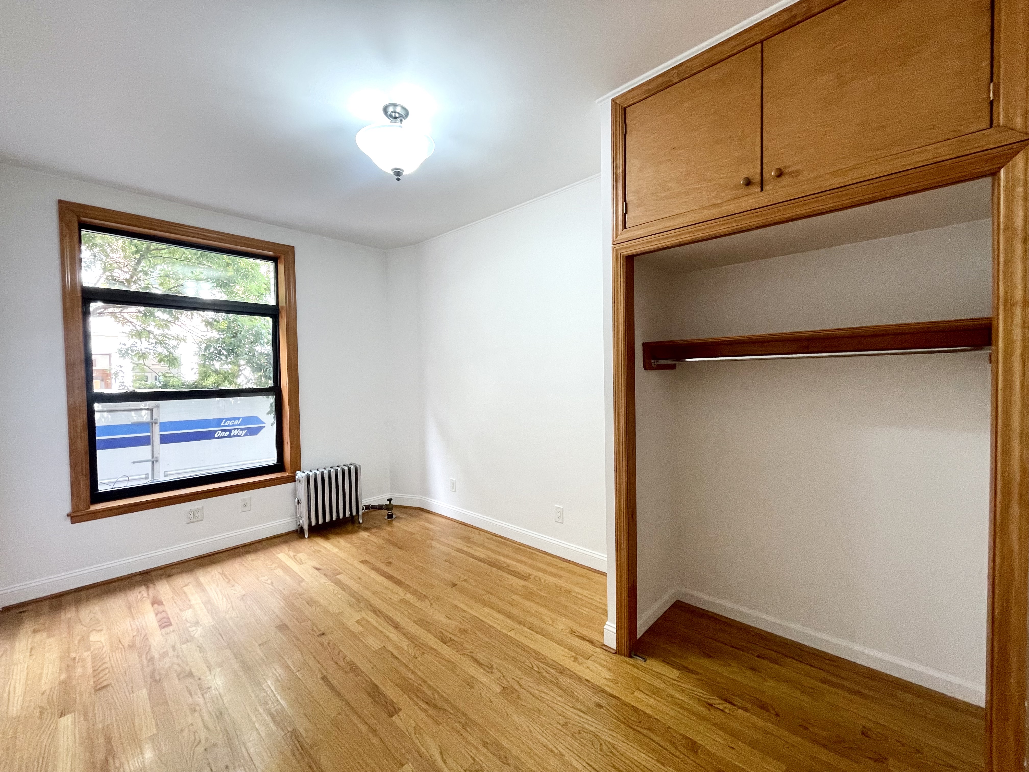 22 St Marks Place, Unit 19 Manhattan, NY 10003 - Photo 4 of 7 an empty room with wooden floor and windows