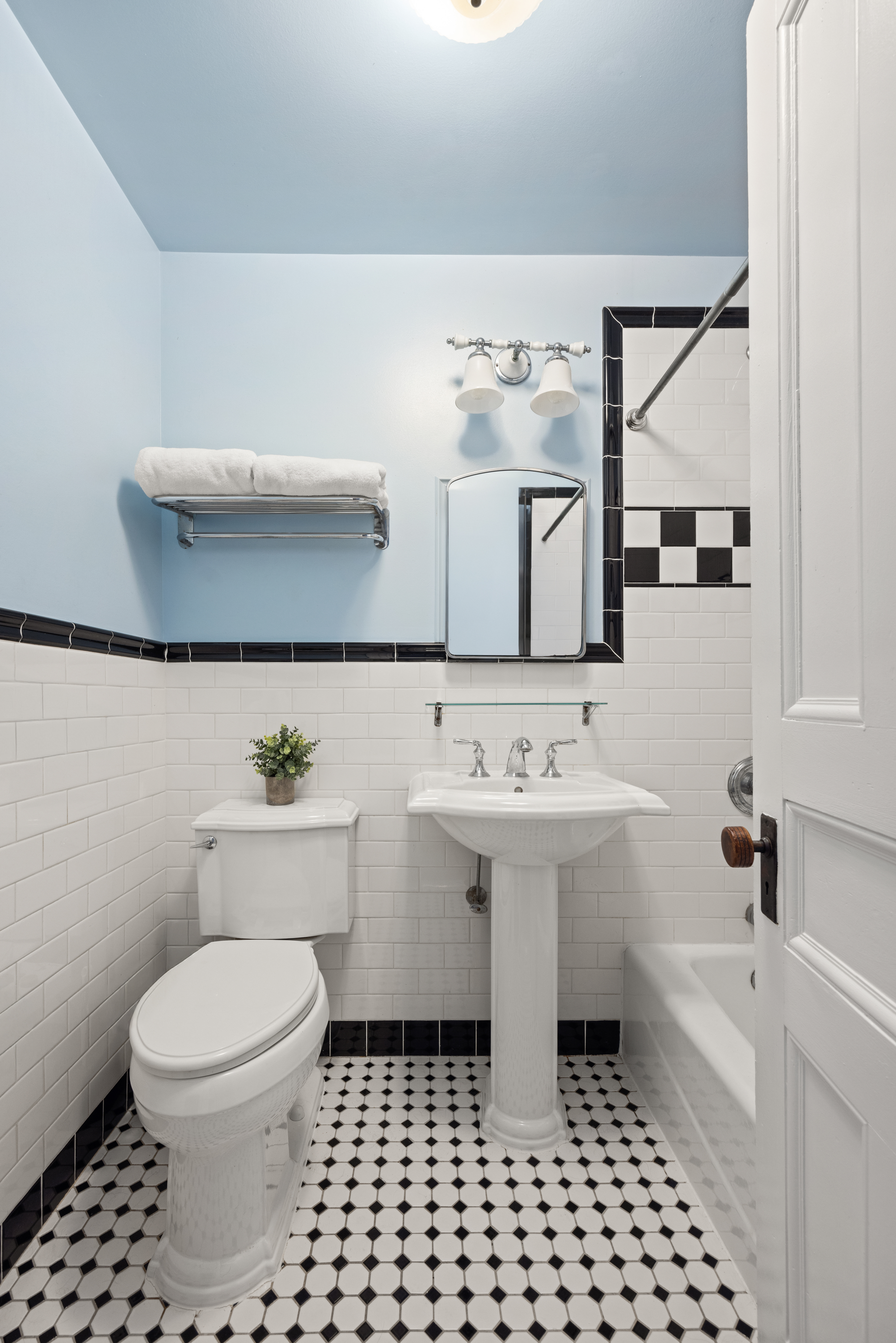 99 East 2nd Street Brooklyn, NY 11218 - Photo 20 of 24 a bathroom with a sink a toilet and mirror