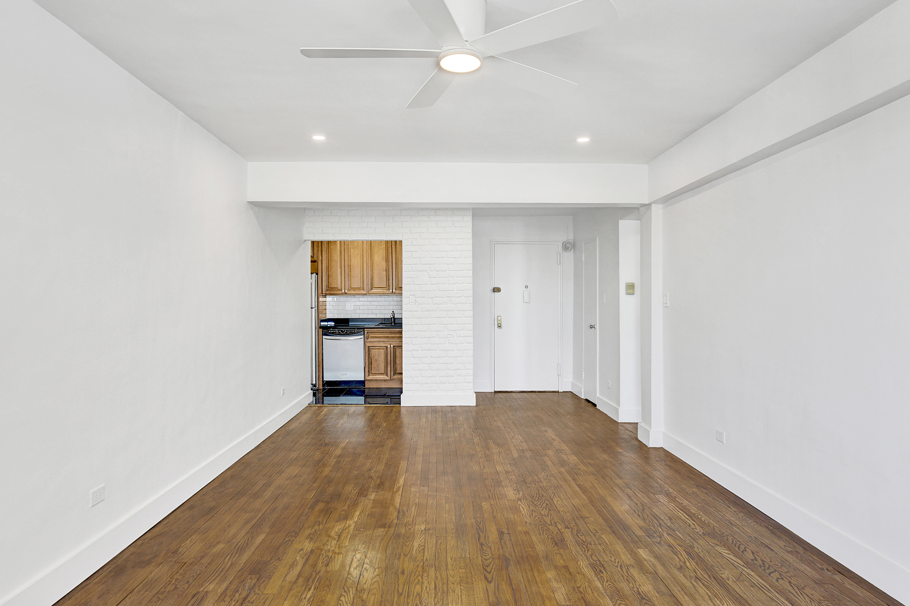 125 Beach 124th Street, Unit 5K Queens, NY 11694 - Photo 10 of 21 an empty room with wooden floor and windows