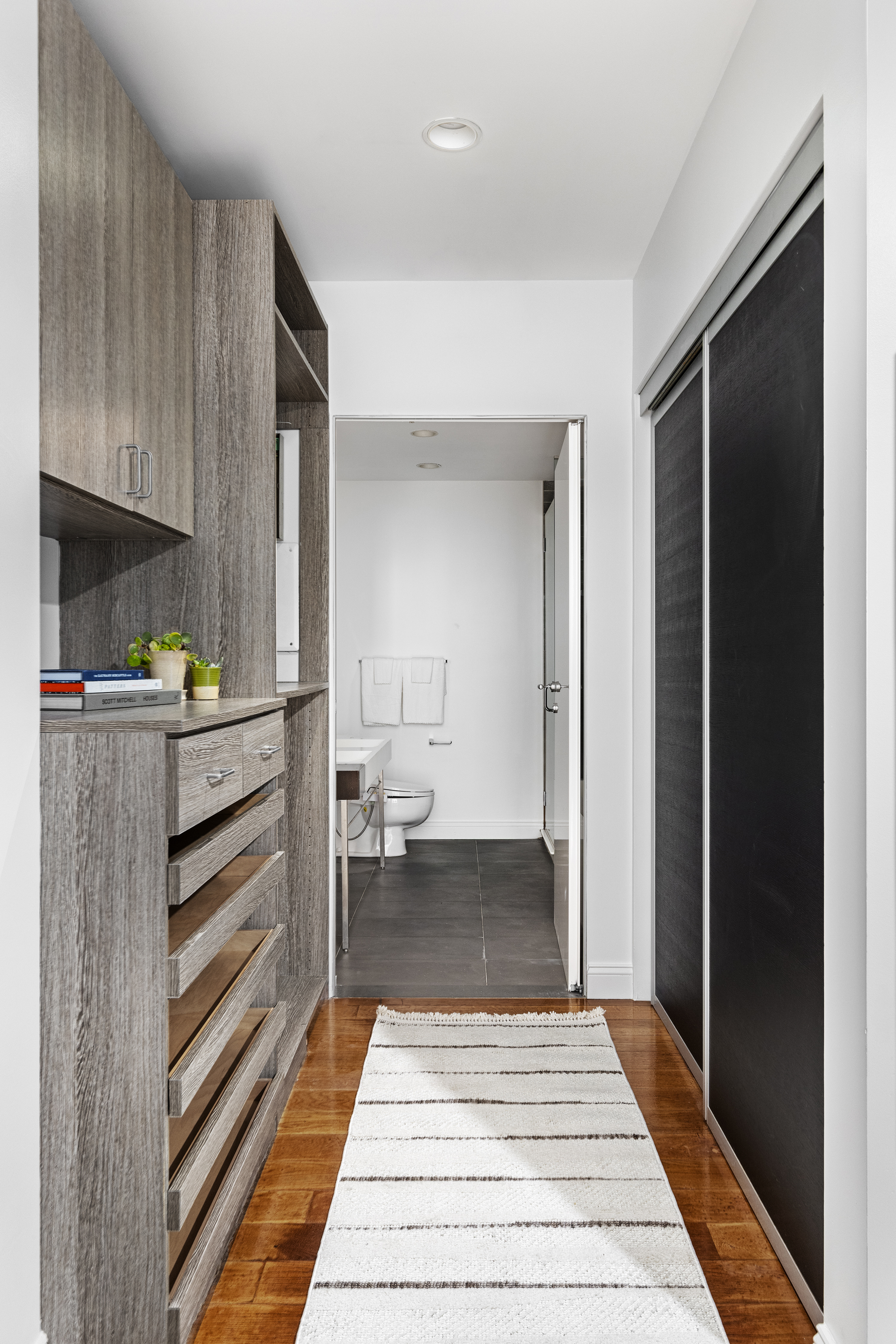 245 10th Avenue, Unit 2W Manhattan, NY 10001 - Photo 12 of 16 a bedroom with a bed and a mirror