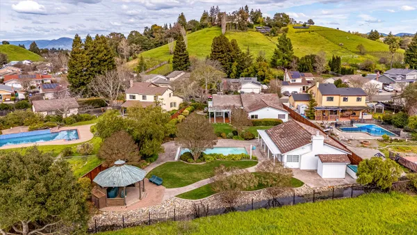 an aerial view of residential houses with outdoor space