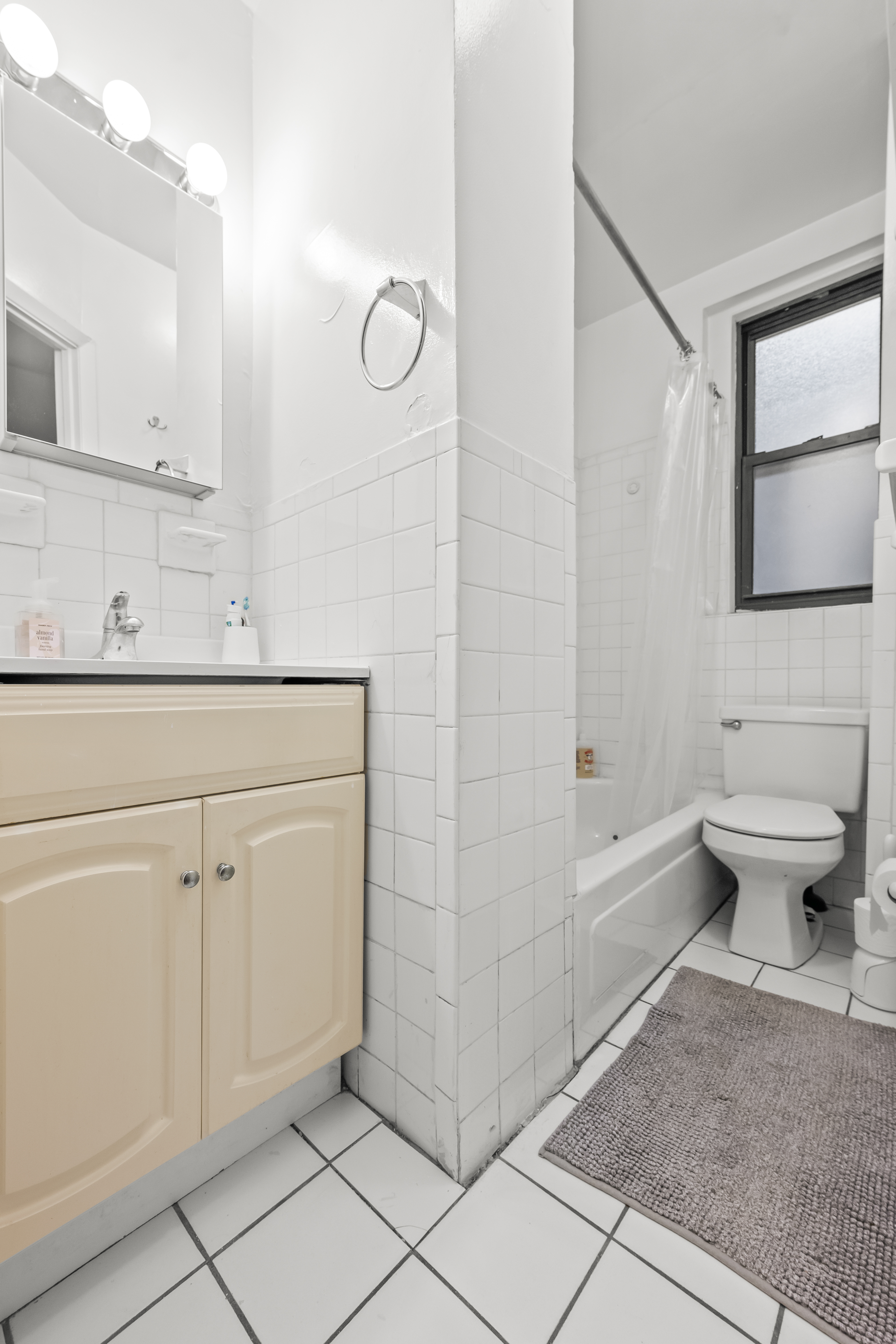 204 West 10th Street, Unit 7A Manhattan, NY 10014 - Photo 14 of 17 a bathroom with a sink a toilet and a mirror