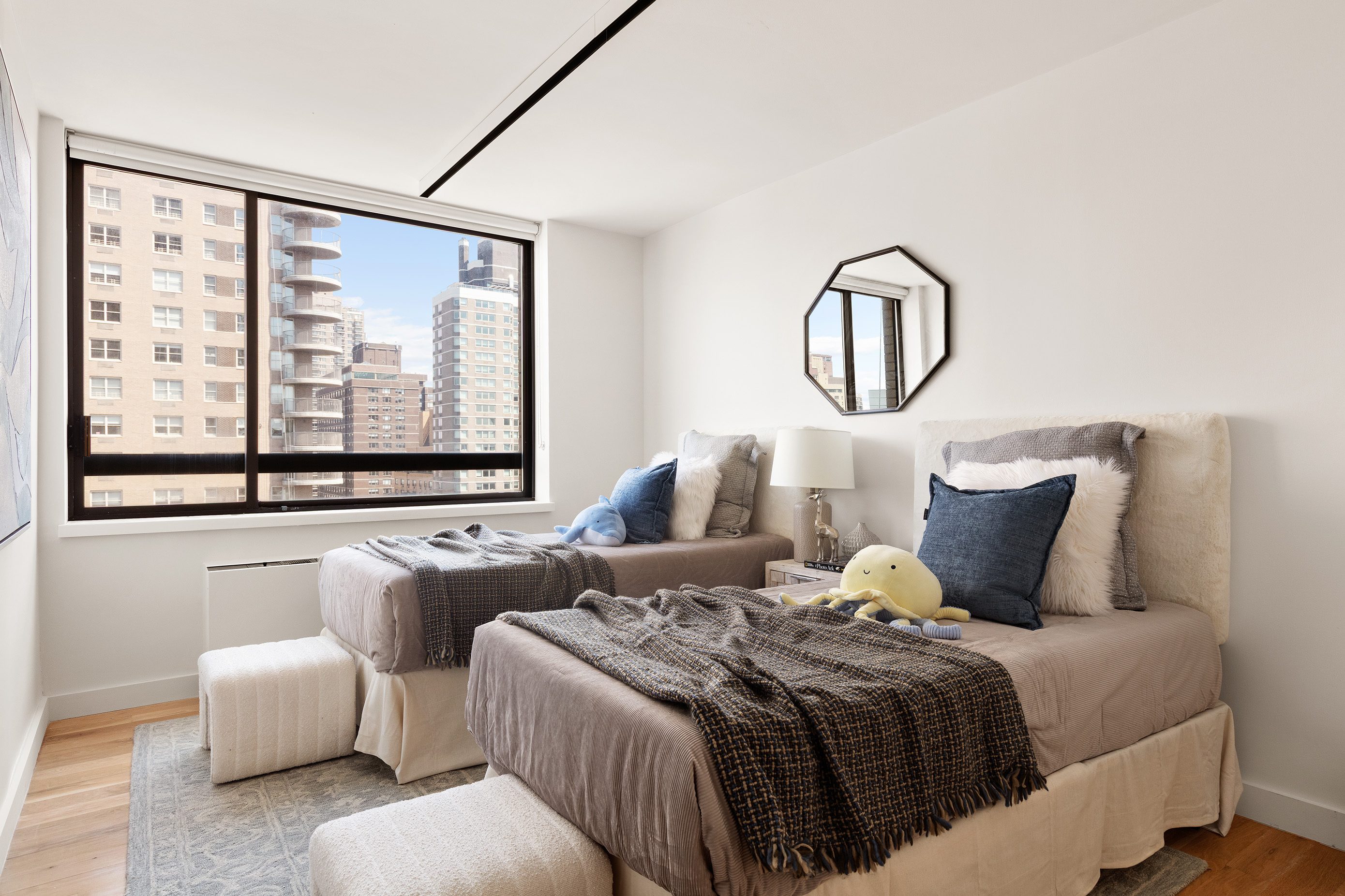 171 East 84th Street, Unit 25B/C Manhattan, NY 10028 - Photo 9 of 13 a bedroom with bed and a large window