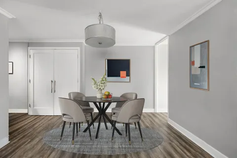 a view of a dining room with furniture and wooden floor
