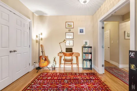 a bedroom with furniture and a rug