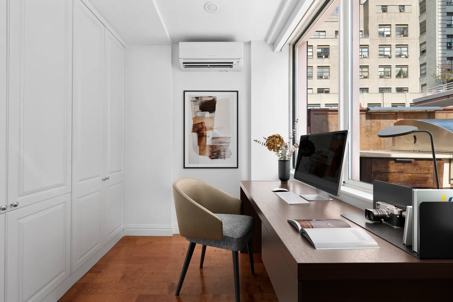 a work room with furniture and wooden floor