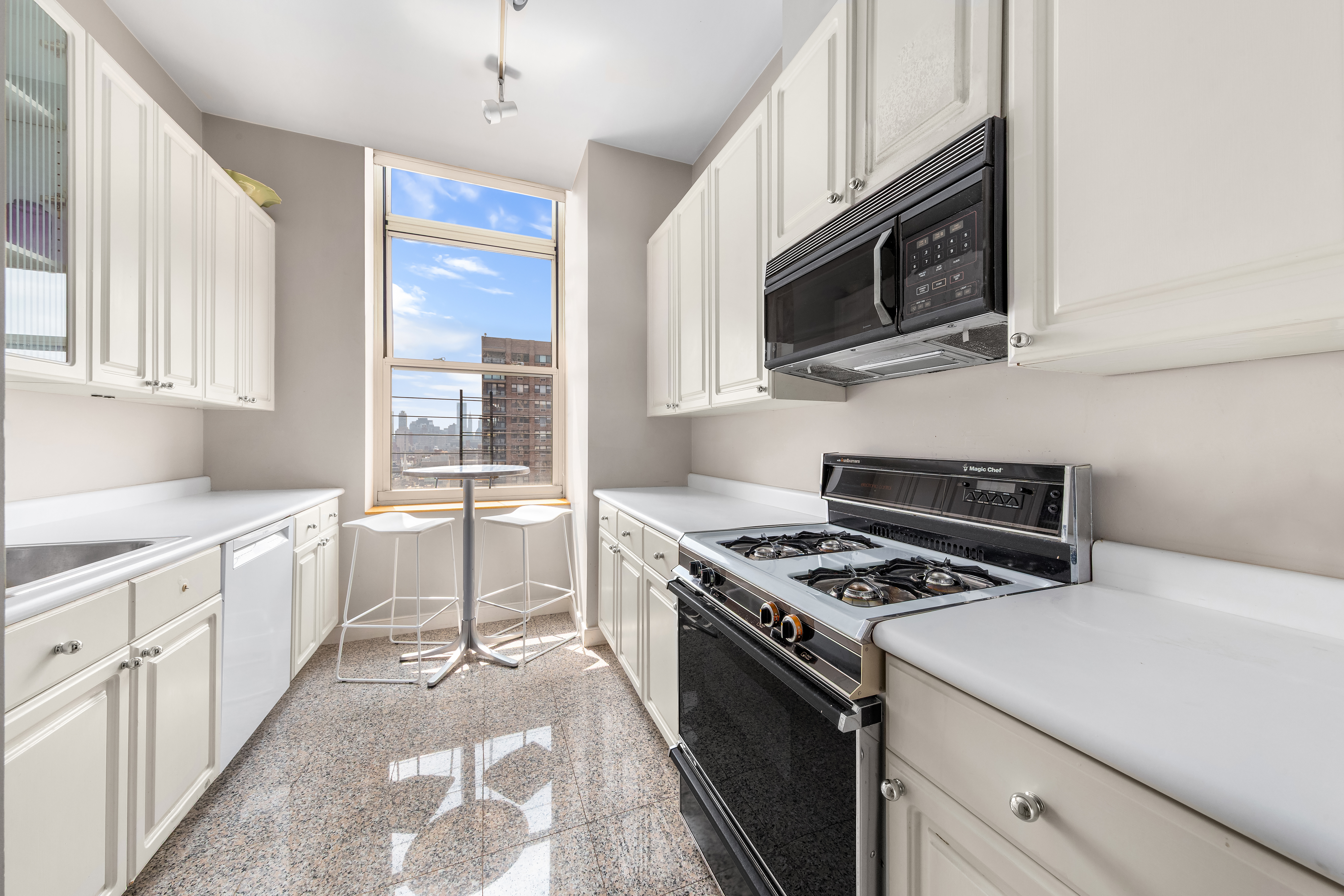 120 East 87th Street, Unit P28B Manhattan, NY 10128 - Photo 2 of 8 a kitchen with granite countertop a sink appliances and cabinets