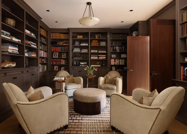 a living room with furniture a rug and a book shelf