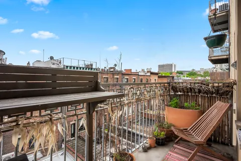 a view of roof deck with two chairs and wooden floor