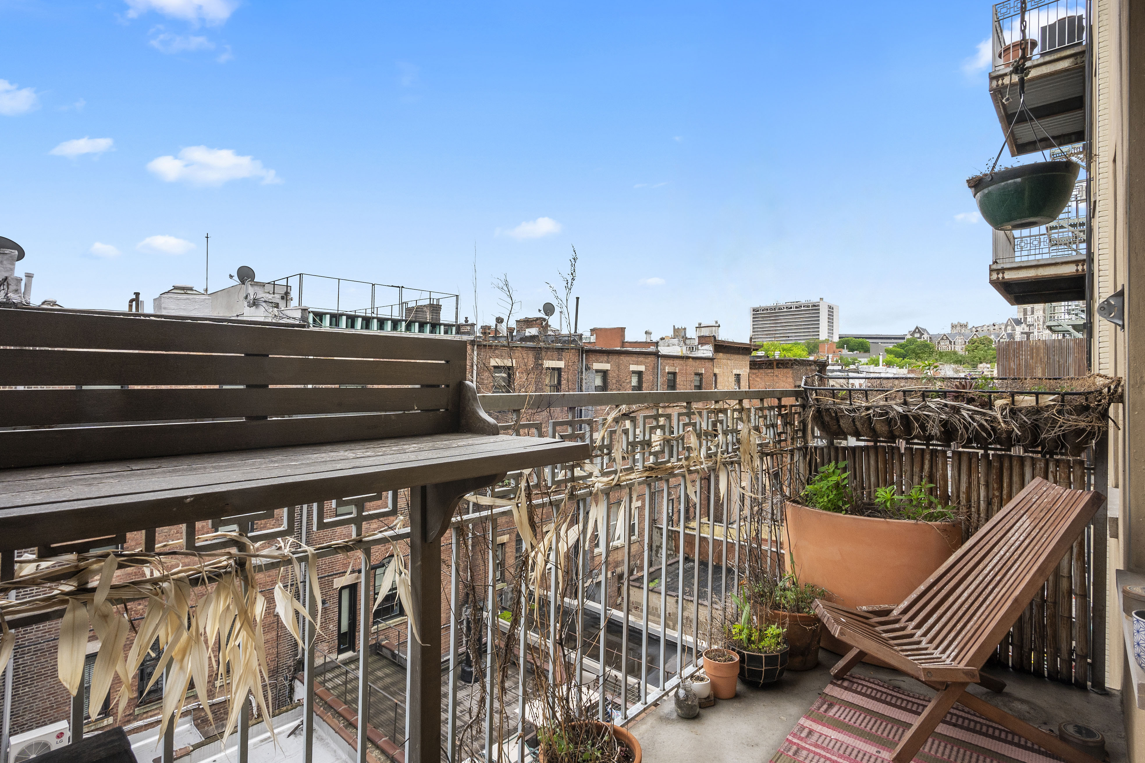 204 West 140th Street, Unit 4D Manhattan, NY 10030 - Photo 6 of 7 a view of roof deck with two chairs and wooden floor