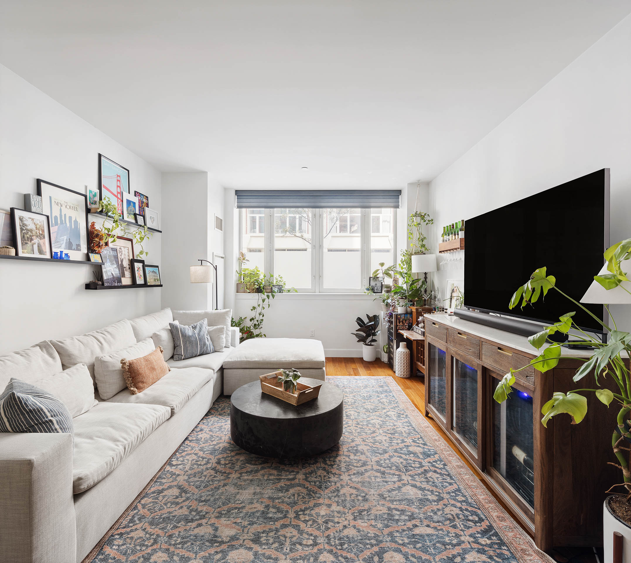 130 West 20th Street, Unit 1B Manhattan, NY 10011 - Photo 2 of 8 a living room with furniture and a flat screen tv