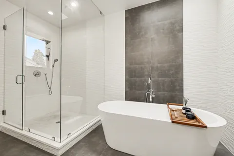 a bathroom with a tub and shower