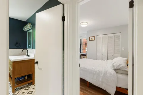 a bedroom with a bed and a dresser