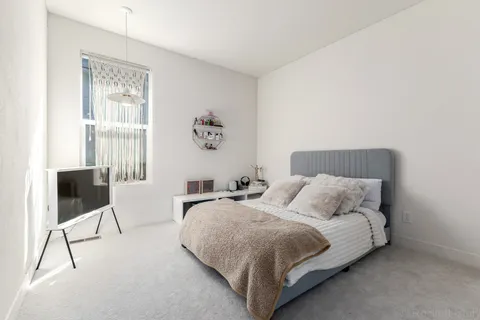 a room with furniture a rug and a window