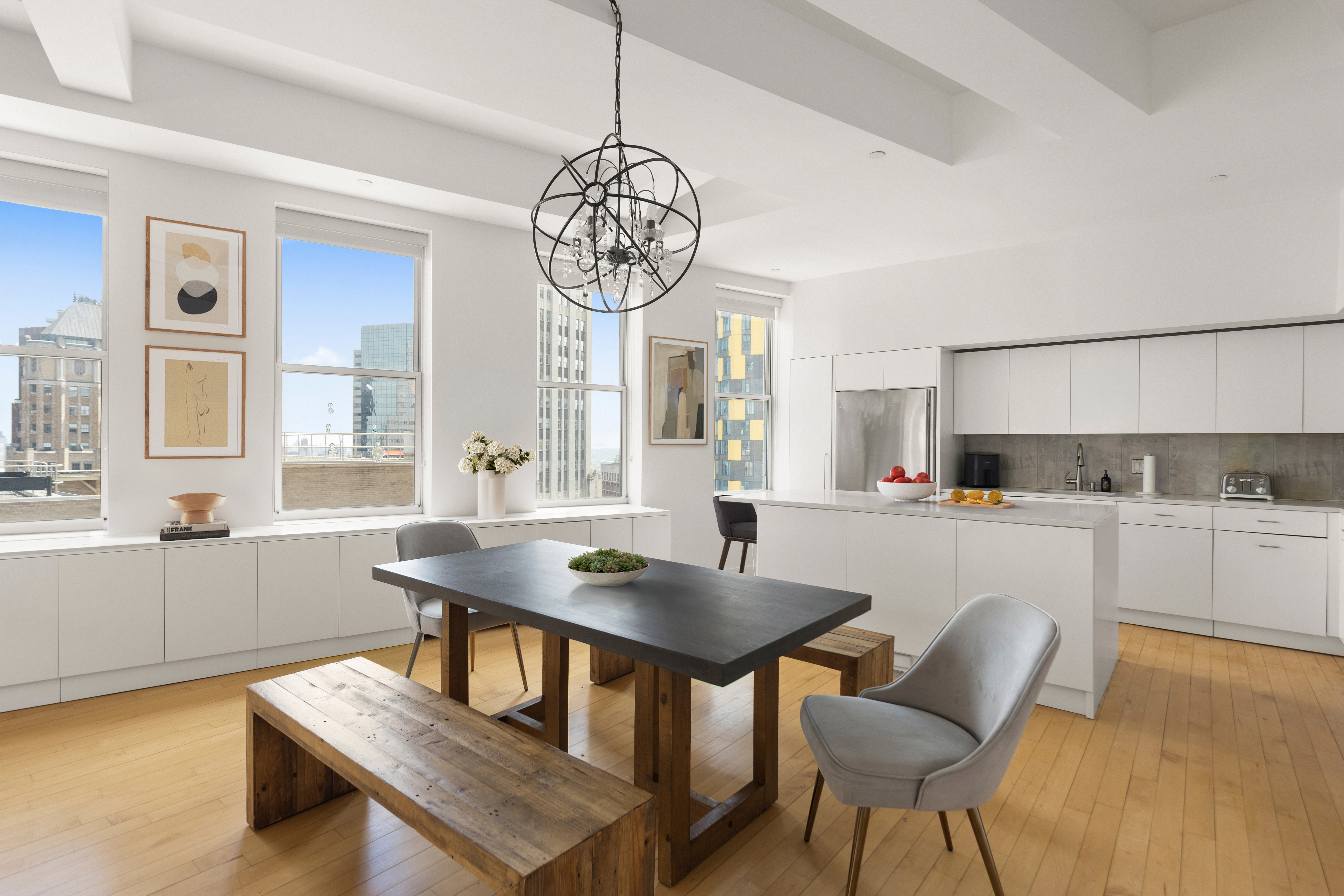 15 Broad Street, Unit 3100 Manhattan, NY 10005 - Photo 4 of 27 a view of a dining room with furniture window and wooden floor