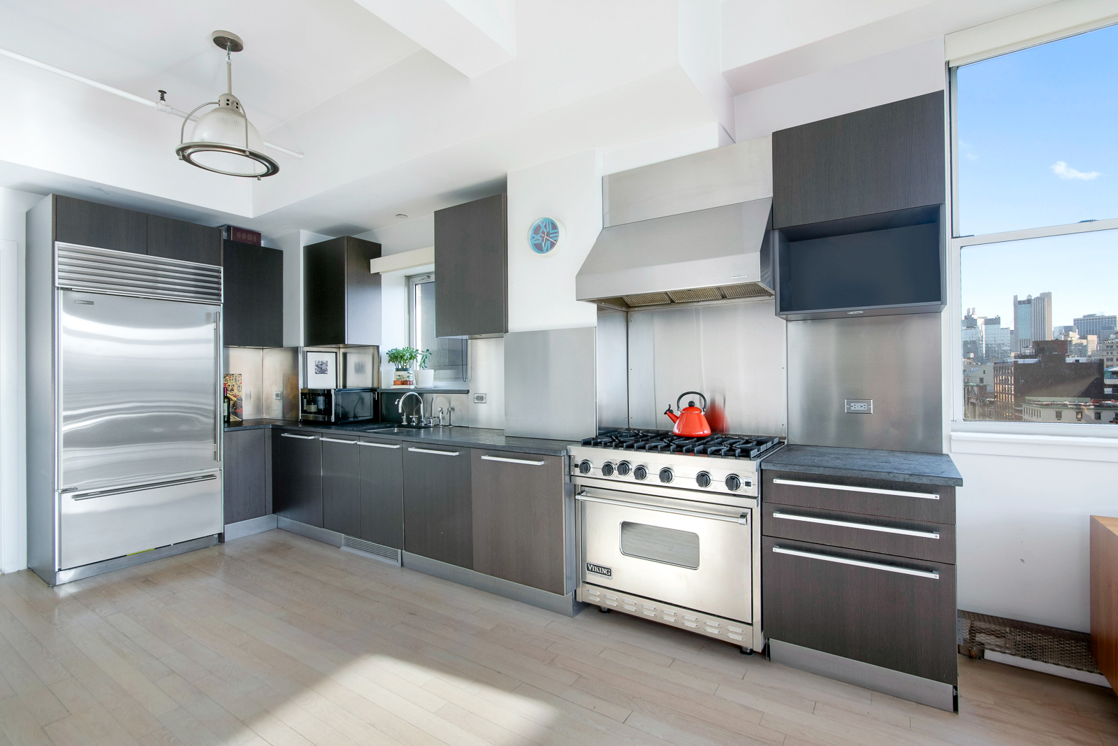 195 Bowery, Unit 7W Manhattan, NY 10002 - Photo 4 of 6 a kitchen with a stove and a refrigerator