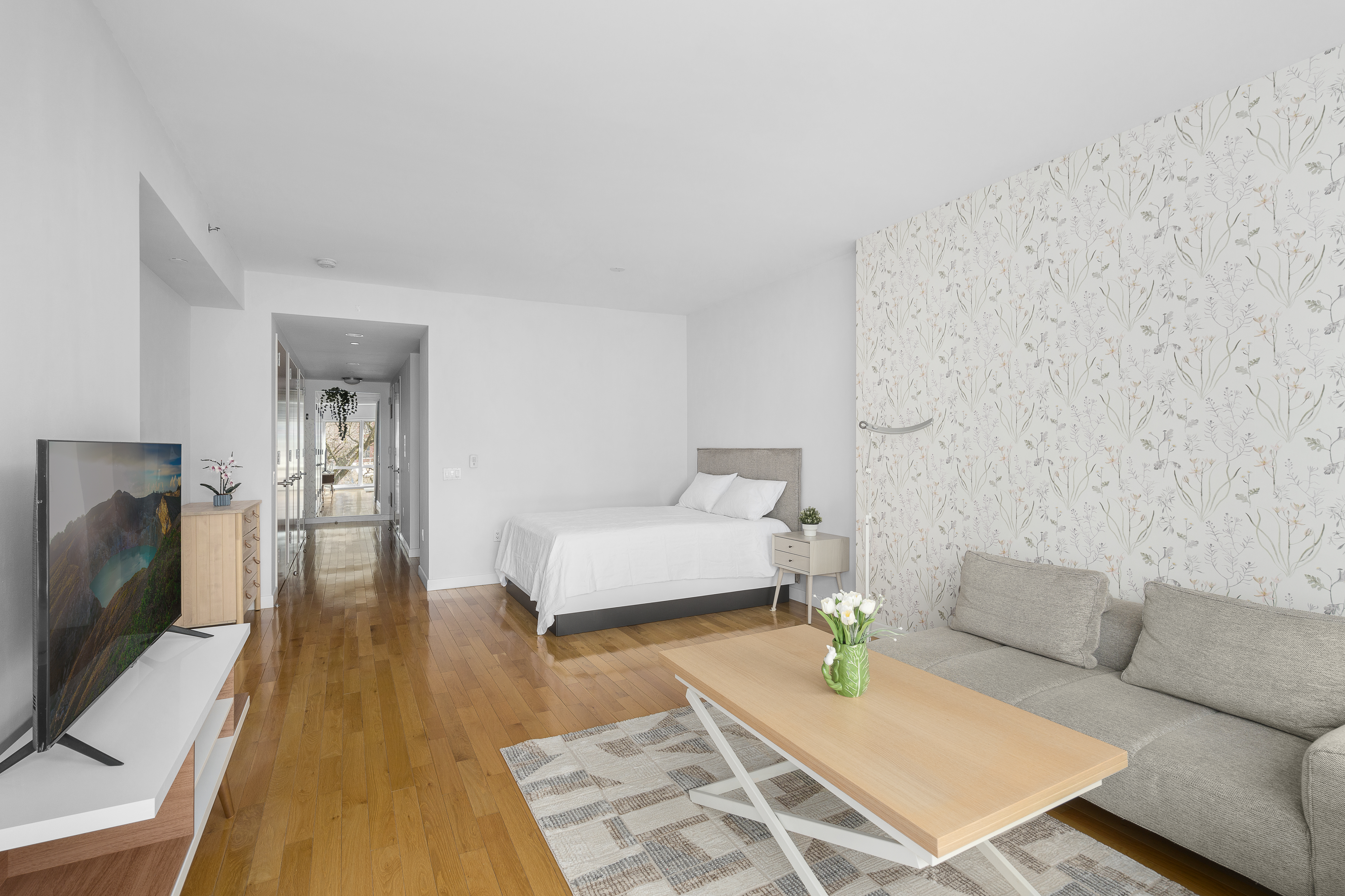 454 West 54th Street, Unit 3N Manhattan, NY 10019 - Photo 3 of 7 a living room with furniture and a flat screen tv