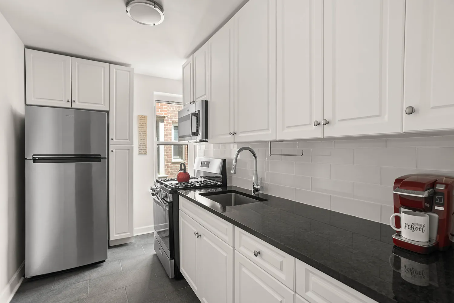 a kitchen with a refrigerator and a sink