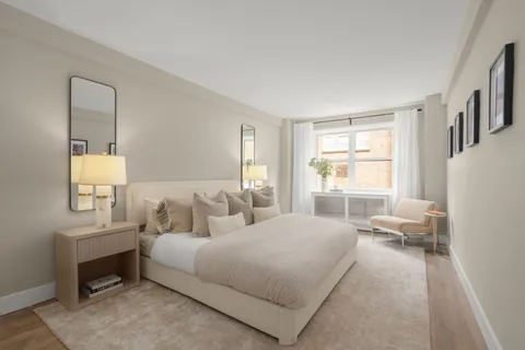 a bedroom with a bed couch and a window
