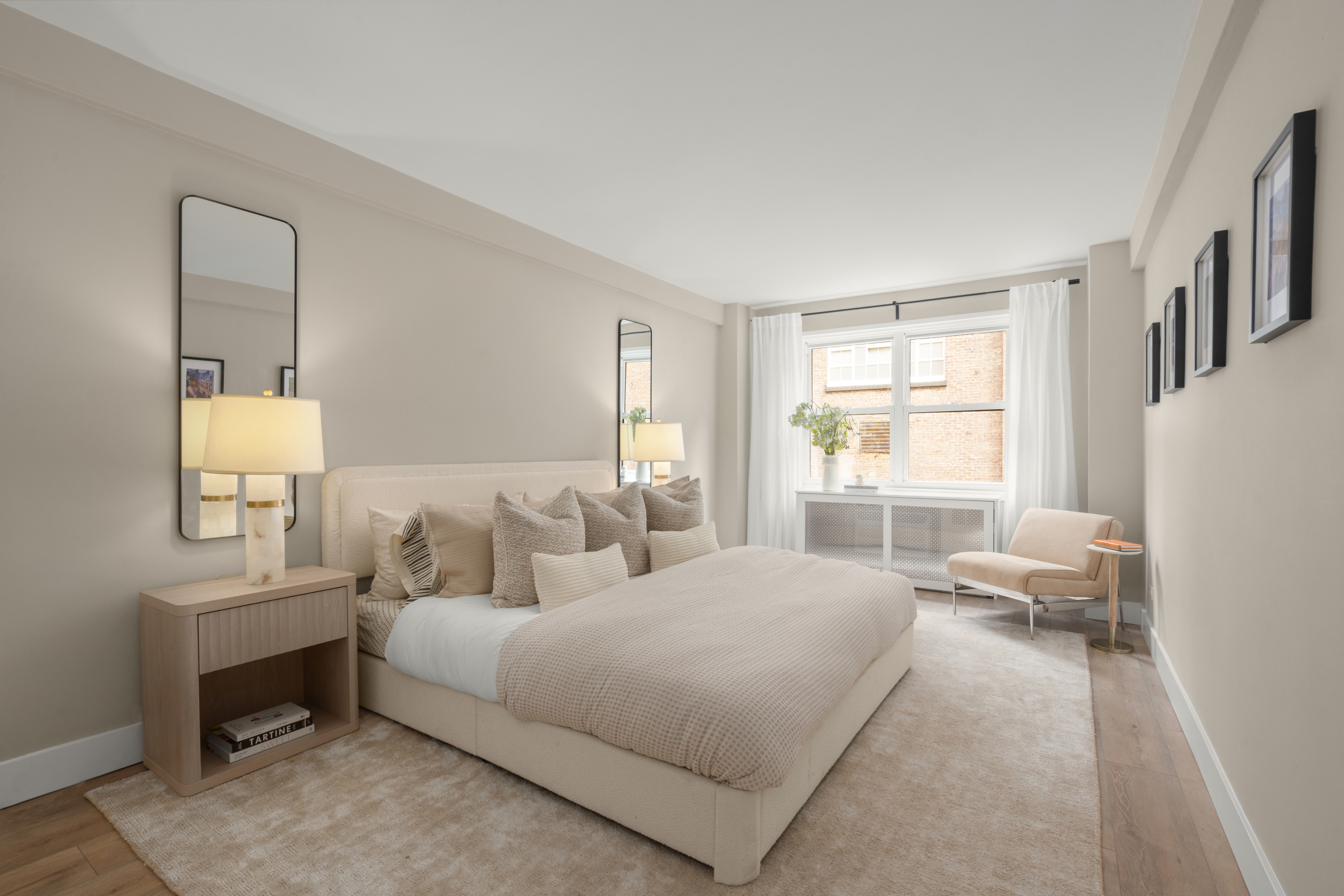 347 East 53rd Street, Unit 2C Manhattan, NY 10022 - Photo 11 of 18 a bedroom with a bed couch and a window