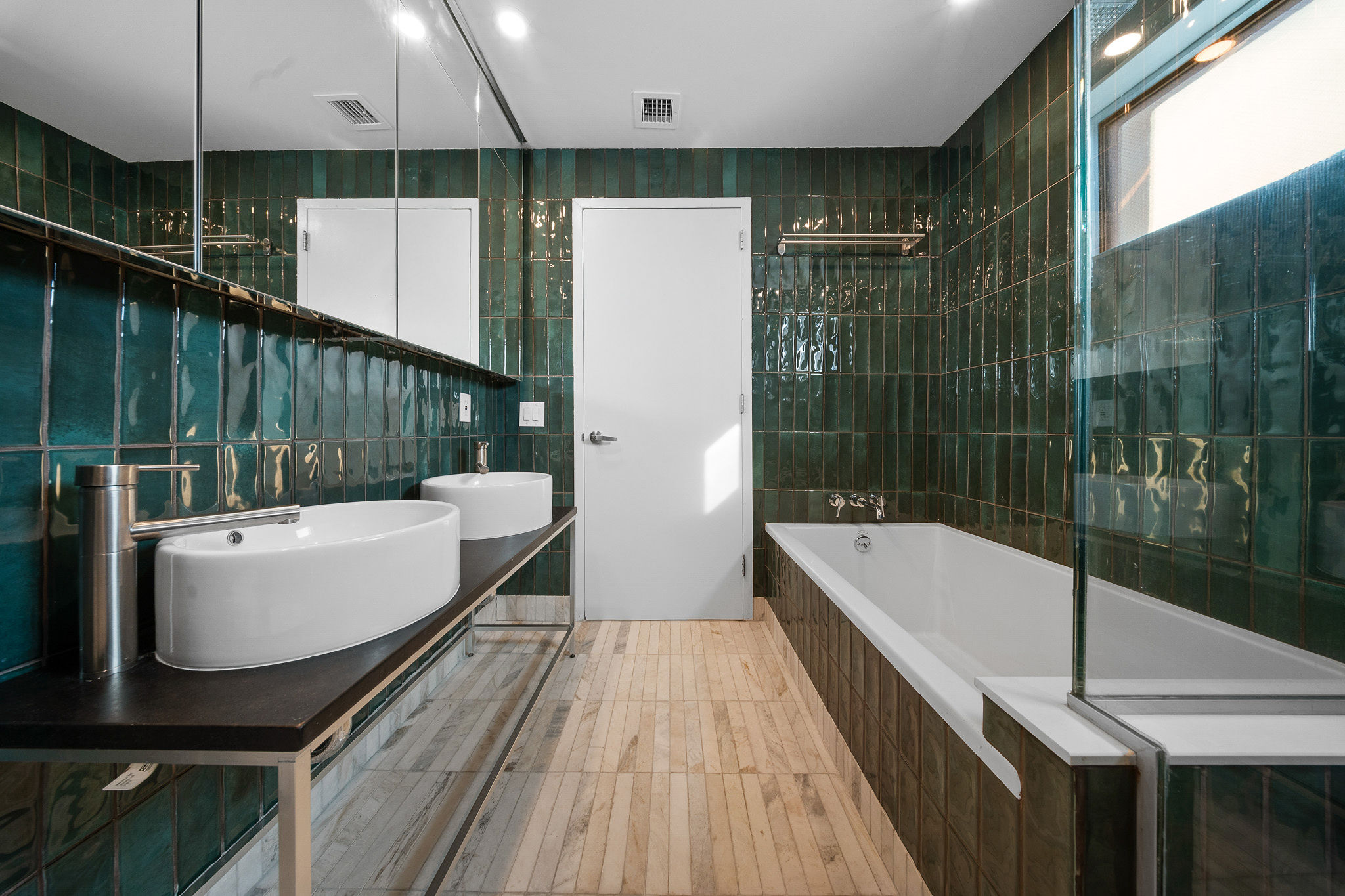 82 Guernsey Street, Unit 3B Brooklyn, NY 11222 - Photo 12 of 18 a bathroom with a bathtub a mirror a window and a shower