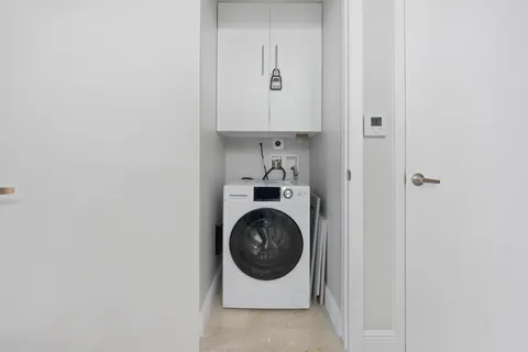 a utility room with sink dryer and washer