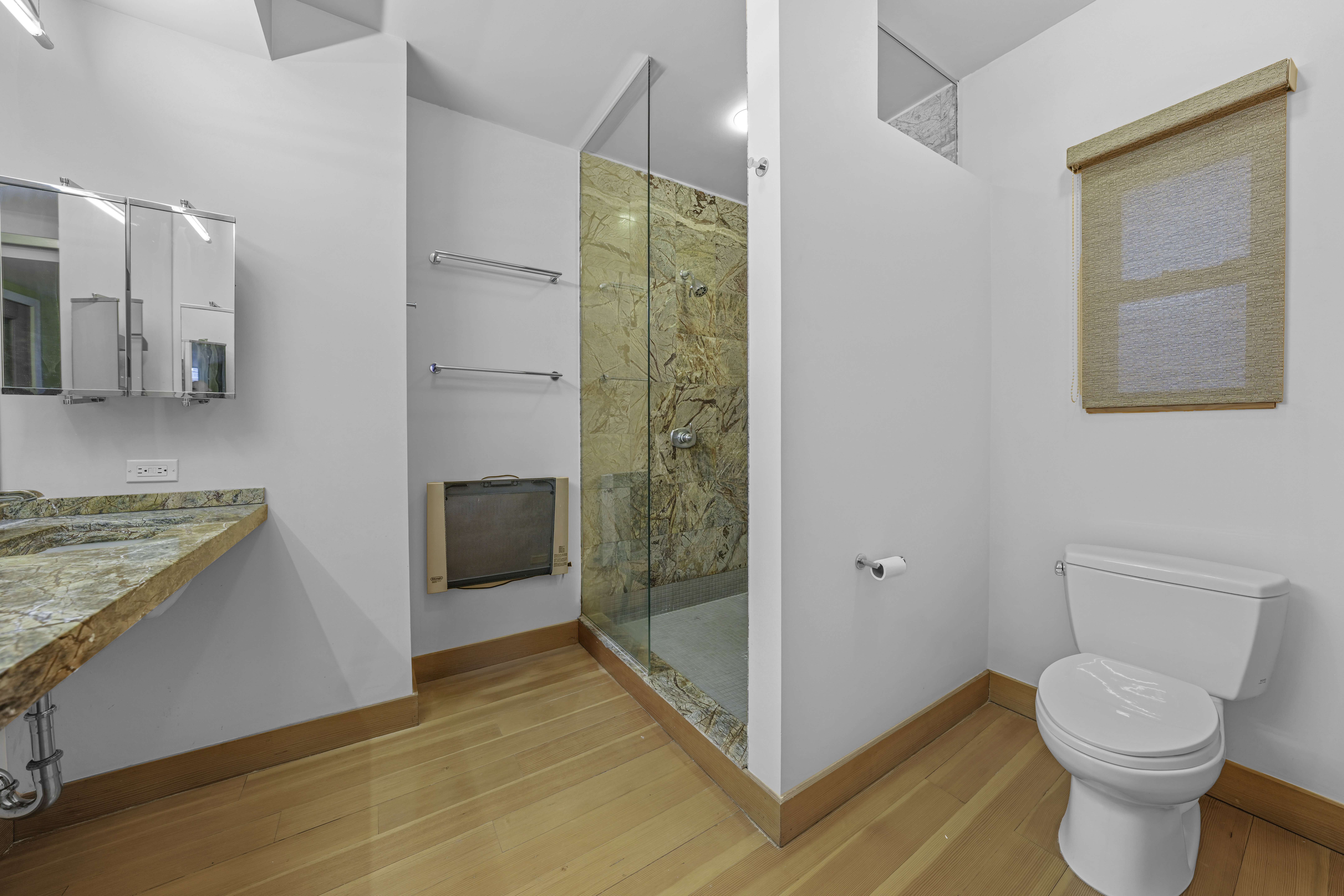 133 West 123rd Street Manhattan, NY 10027 - Photo 21 of 31 a bathroom with a granite countertop sink a toilet and shower